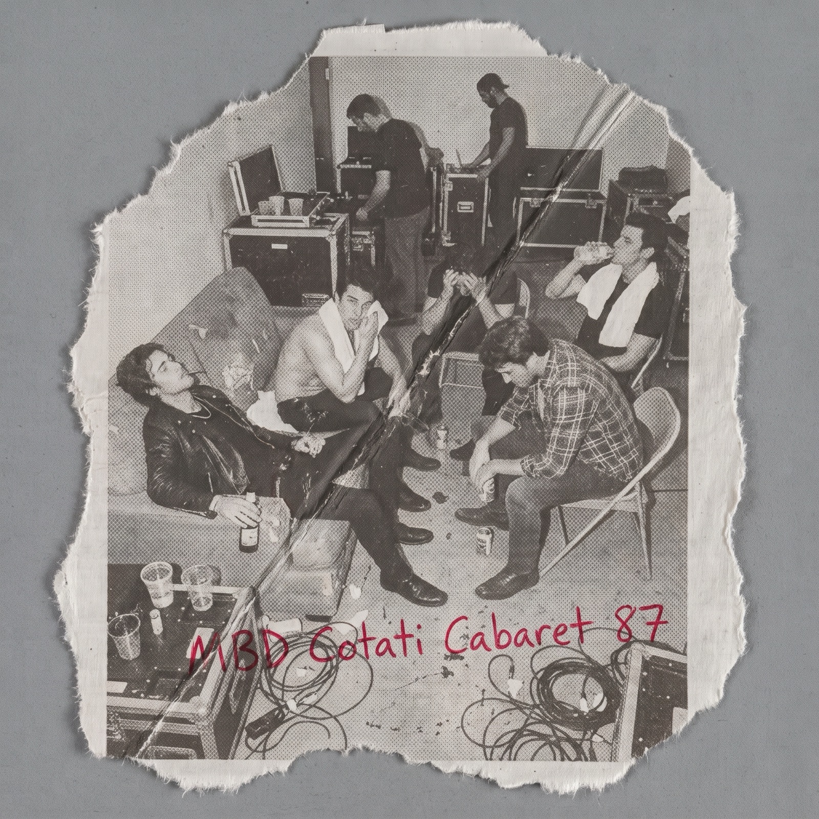 Torn photocopy of a backstage photograph